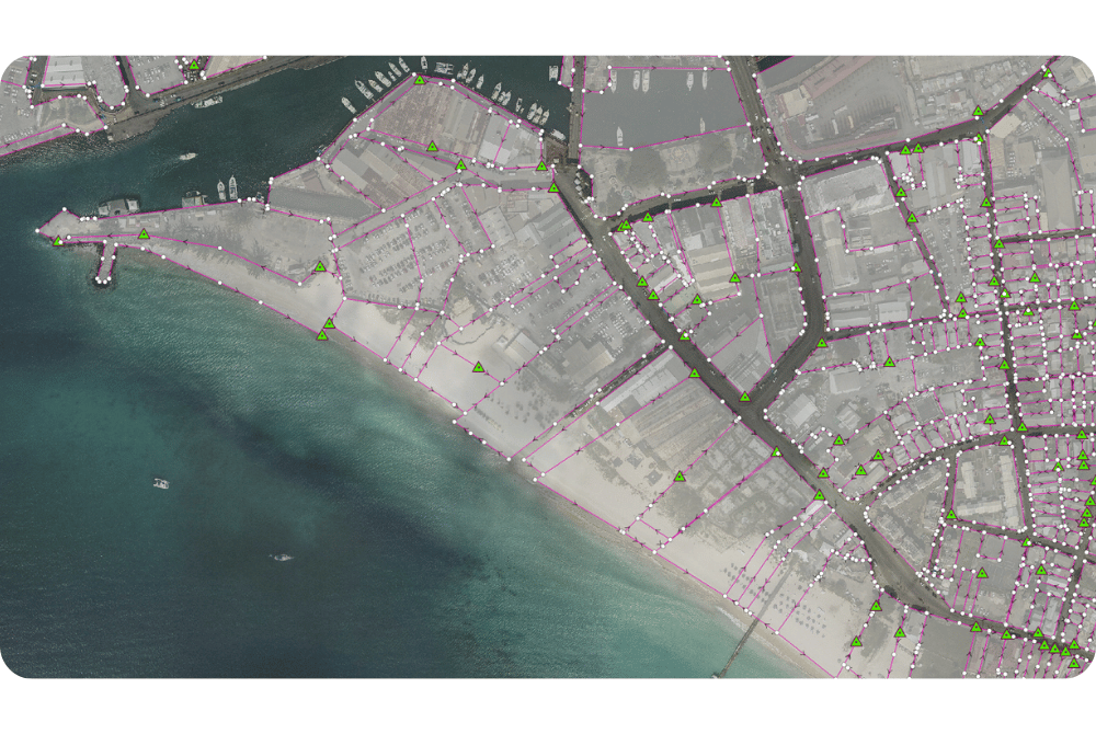 ArcGIS Pro parcel fabric map of digitized land tax parcels along a Barbados coastline, part of a nationwide digital cadastre.