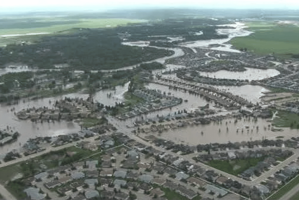 Aerial view of flooding in the community of High River, with water covering residential streets and neighborhoods